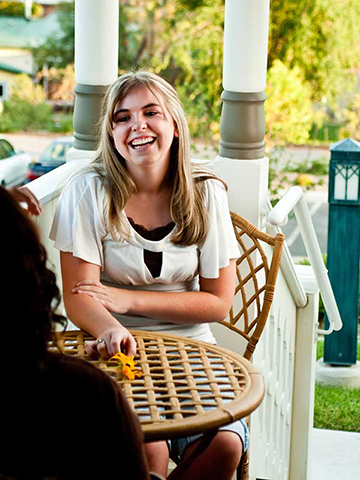 women talking on porch