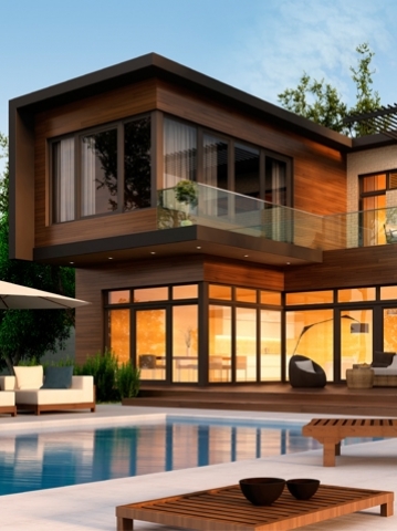 Two story contemporary wooden home with pool in the evening