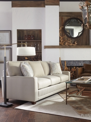 Living room with beige sofa, hardwood floors, and brown accents