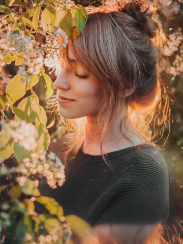 Woman with blooming flowers tree