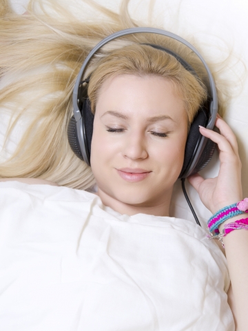 Relaxed girl enjoying sleeping sounds